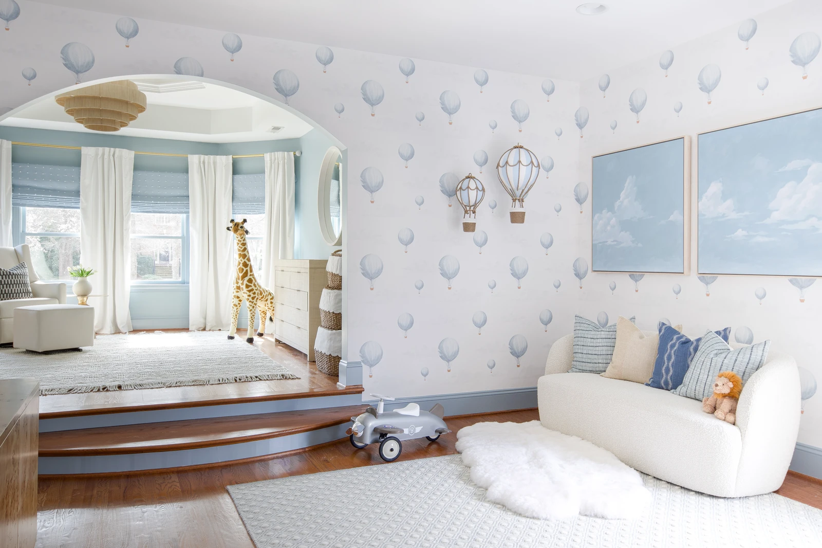 Beautifully designed nursery with hot air balloon wallpaper by Onyx Interiors