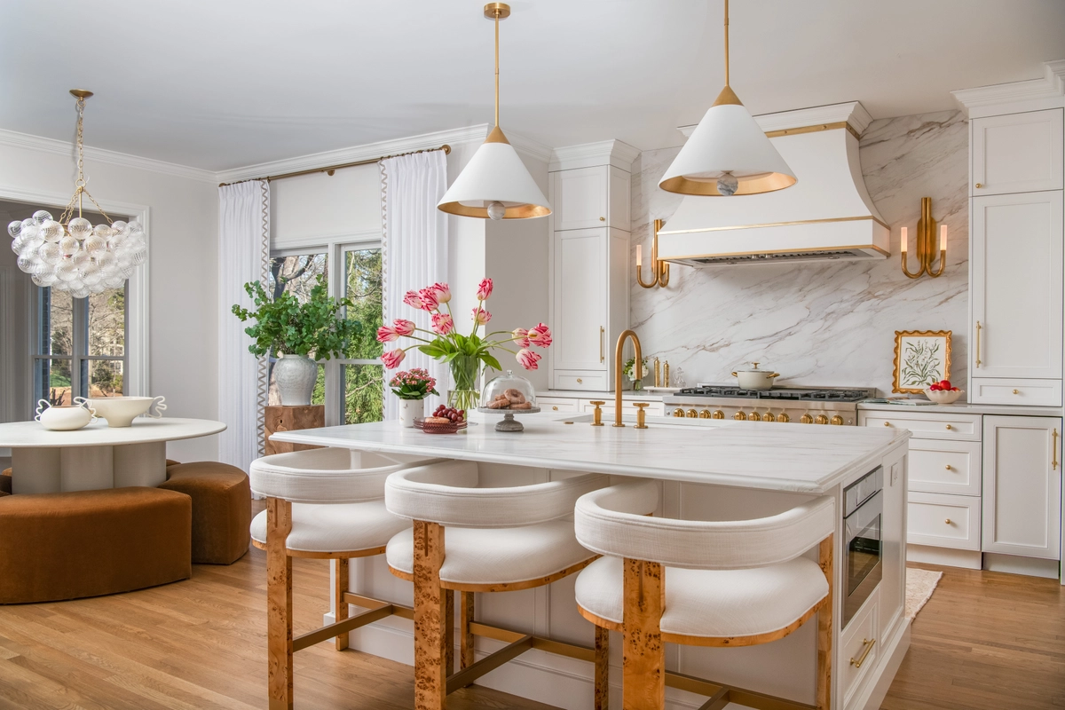 Wide view of the kitchen with island seating, breakfast nook, and pendant lighting
