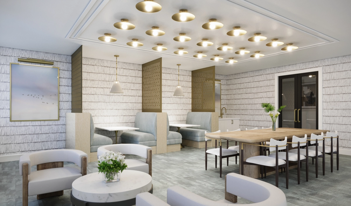 Mezzanine dining and lounge space with light blue upholstered booth seating in partitioned alcoves, a long wooden communal table with white chairs, round marble side tables, textured wallpaper, and recessed gold ceiling lights