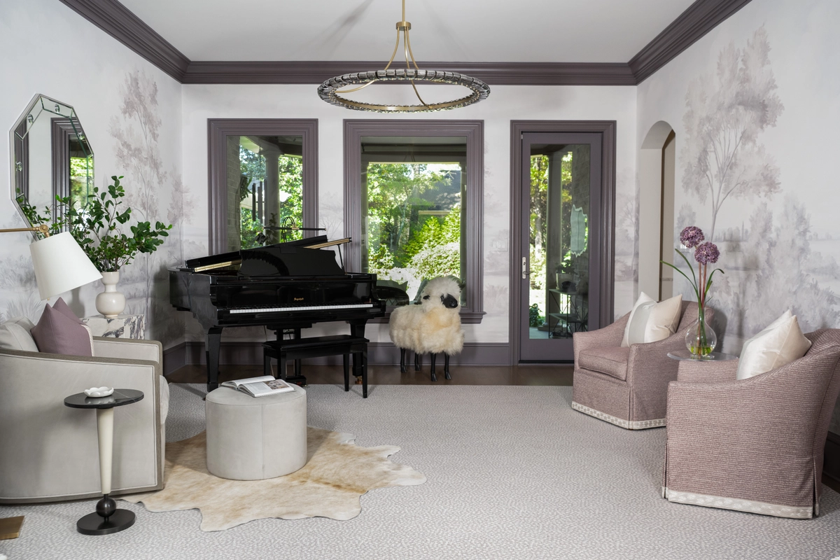 Formal piano room with a black grand piano, gray tree mural wallpaper, mauve swivel chairs, a cowhide rug, and circular brass chandelier