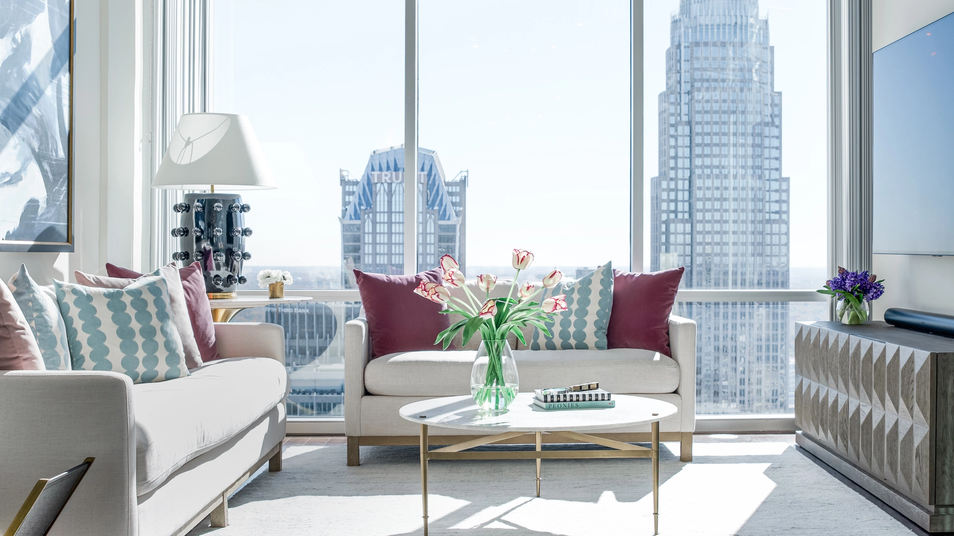 Highrise living room with Charlotte skyline view