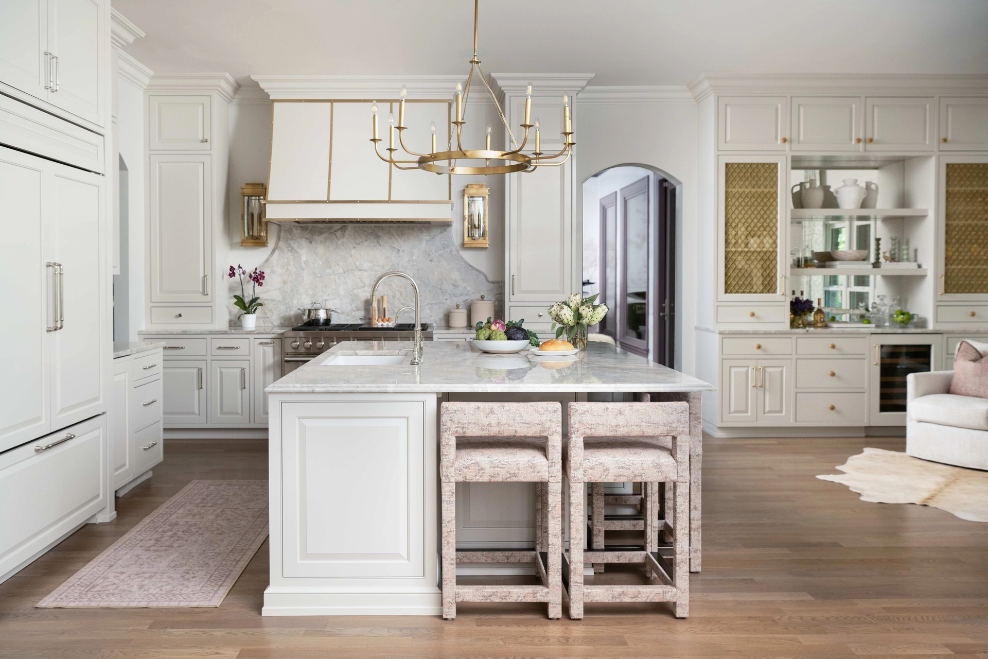Luxury white kitchen with marble island and gold accents