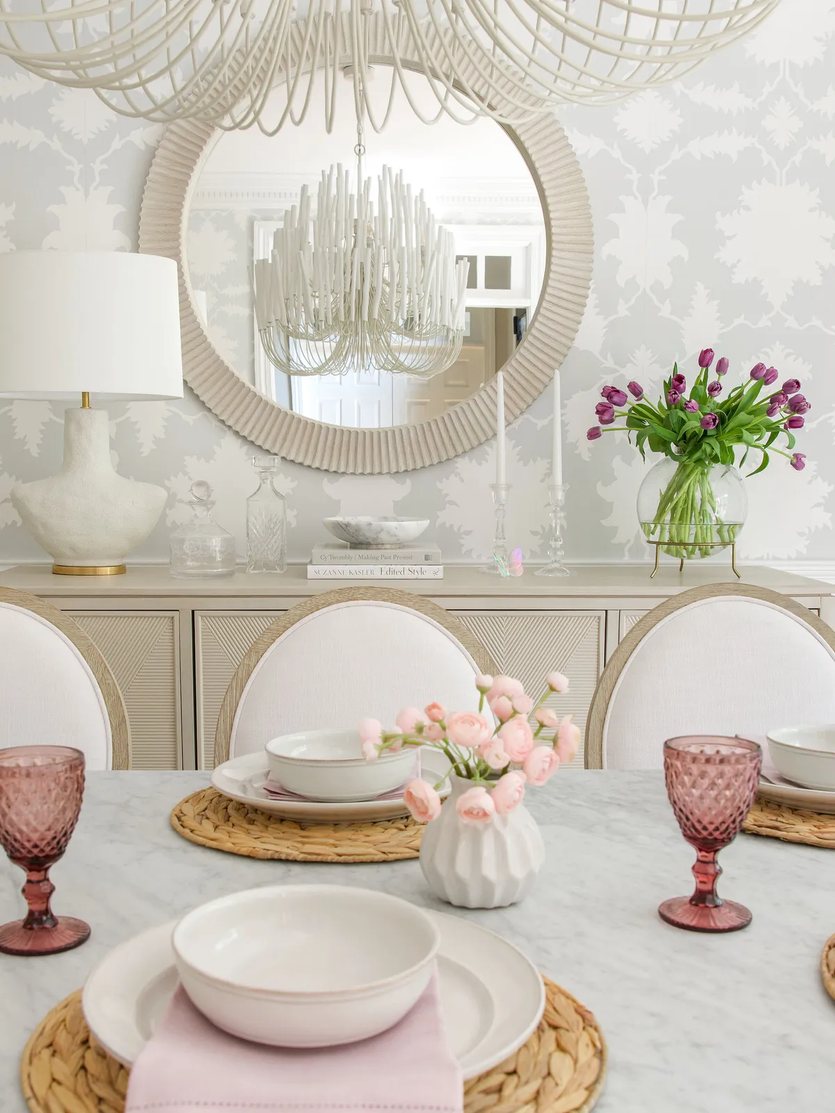 Refined sideboard vignette with mirror and floral arrangement