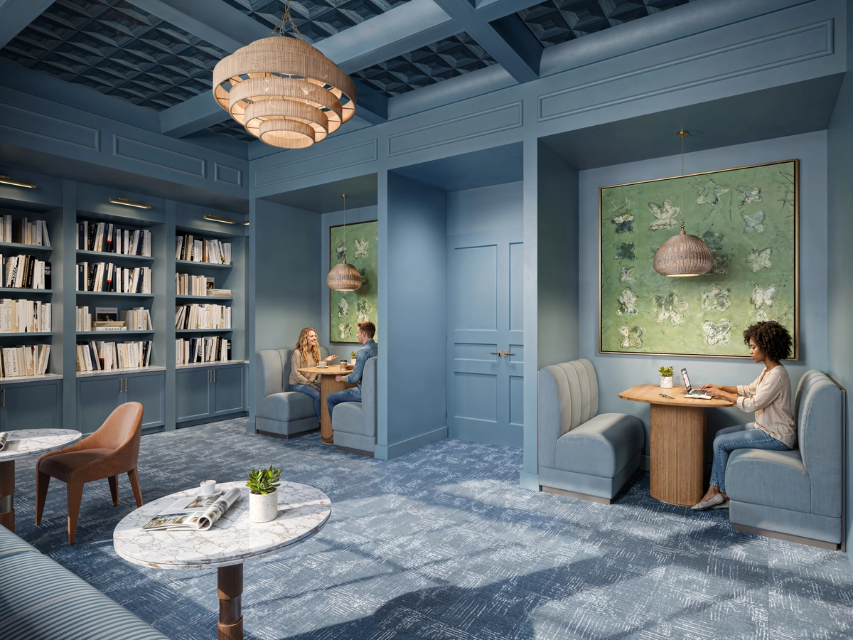 Co-working library lounge rendering with blue paneled walls, built-in bookshelves, upholstered booth seating, butterfly artwork, rattan tiered chandelier, and marble coffee tables